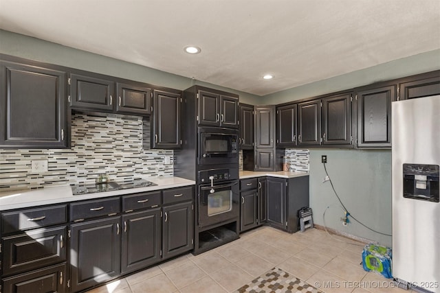 kitchen with light countertops, recessed lighting, light tile patterned floors, tasteful backsplash, and black appliances
