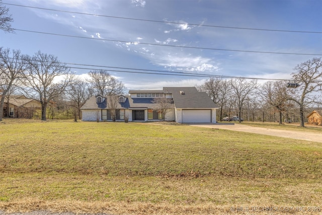 view of front of property featuring driveway, an attached garage, and a front lawn