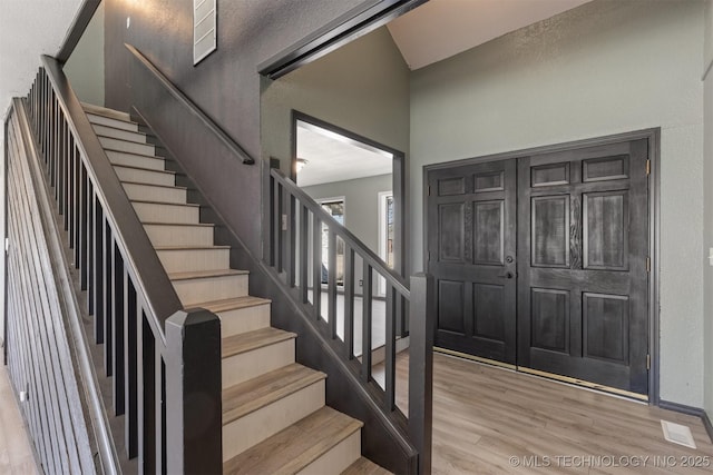 entryway featuring light wood-style floors and stairway