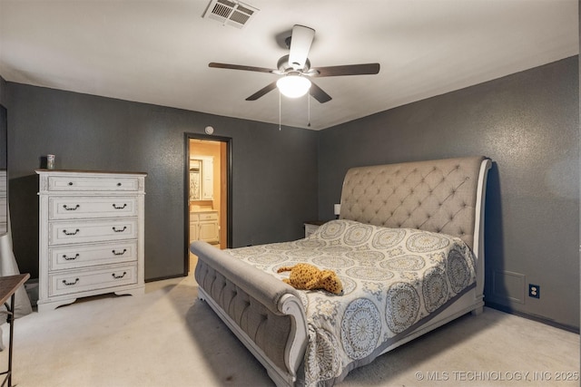 bedroom with visible vents, connected bathroom, ceiling fan, and light carpet