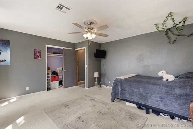 carpeted bedroom with baseboards, visible vents, ceiling fan, and a closet
