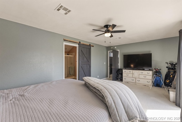 bedroom with ceiling fan, visible vents, a barn door, and light carpet