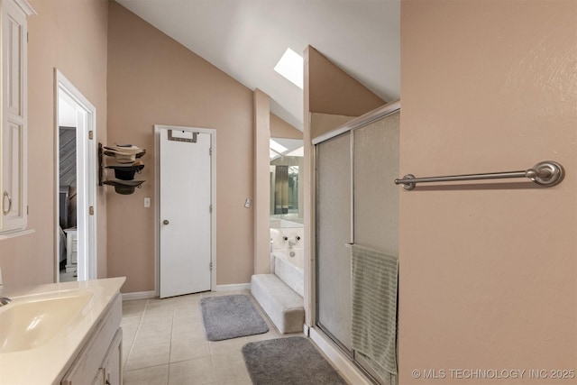 full bath featuring vanity, a garden tub, lofted ceiling with skylight, and a stall shower