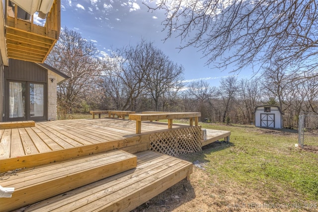deck with french doors, an outbuilding, a yard, and a shed