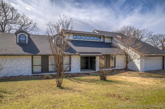 view of front facade with a shingled roof, an attached garage, a front lawn, and stone siding