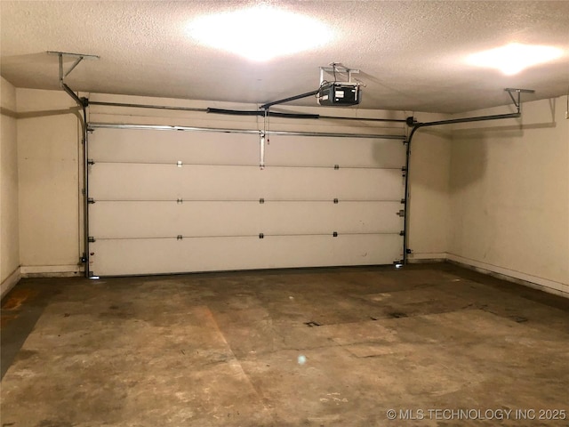 garage with a garage door opener and baseboards