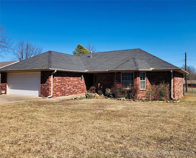 single story home with roof with shingles, a front lawn, and brick siding