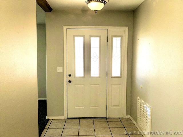 foyer entrance featuring visible vents, baseboards, and light tile patterned floors