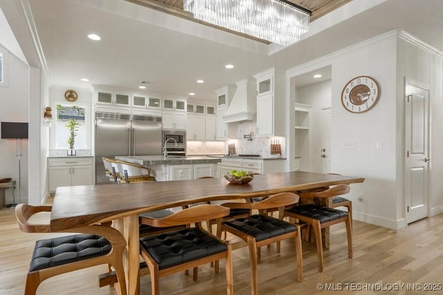 dining area with recessed lighting, baseboards, and light wood finished floors