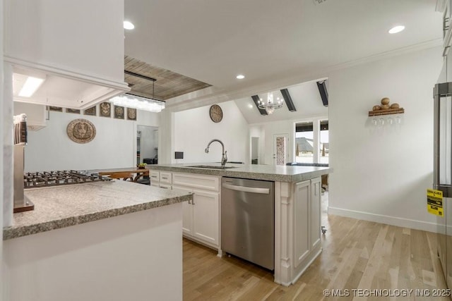 kitchen featuring appliances with stainless steel finishes, white cabinets, a sink, and light wood finished floors