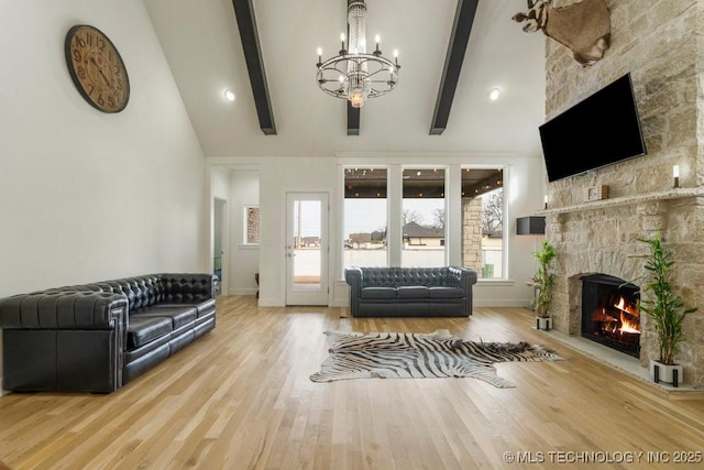 living room with high vaulted ceiling, a fireplace, wood finished floors, and beam ceiling