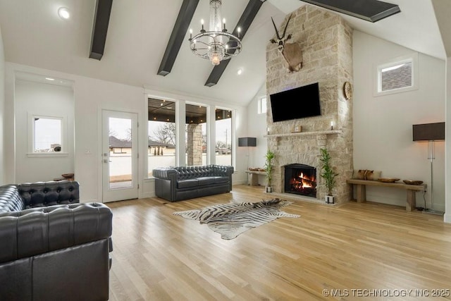 living area featuring a fireplace, high vaulted ceiling, wood finished floors, and beamed ceiling