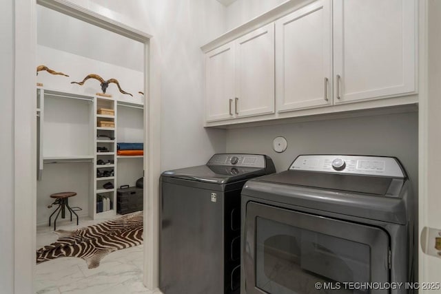 washroom with marble finish floor, cabinet space, and independent washer and dryer