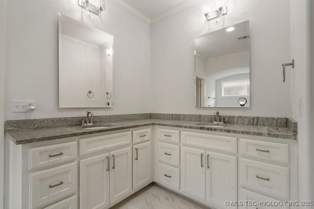 bathroom with double vanity, marble finish floor, crown molding, and a sink