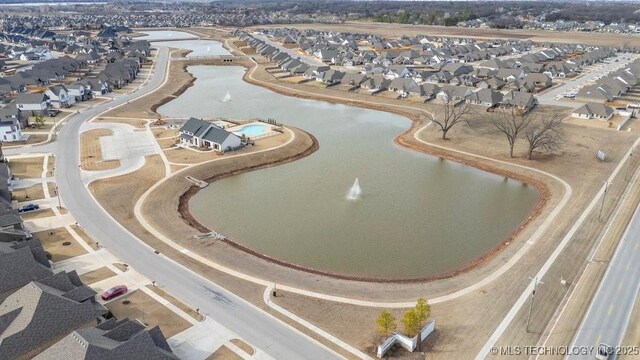 birds eye view of property with a water view and a residential view