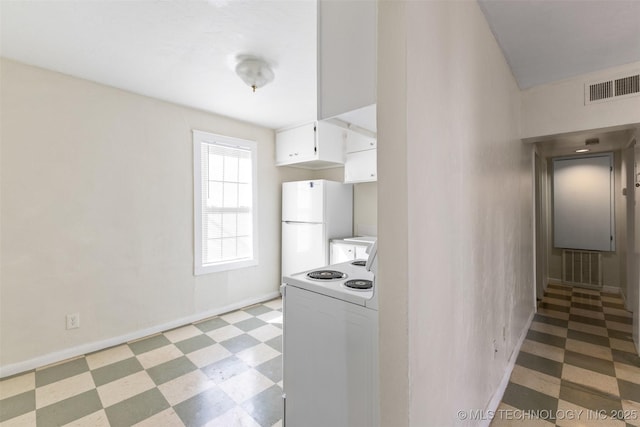 kitchen with light floors, visible vents, white appliances, and light countertops