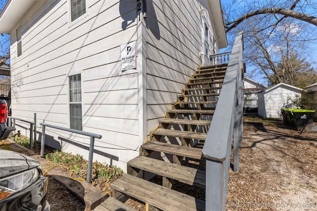 view of home's exterior featuring an outbuilding and stairs