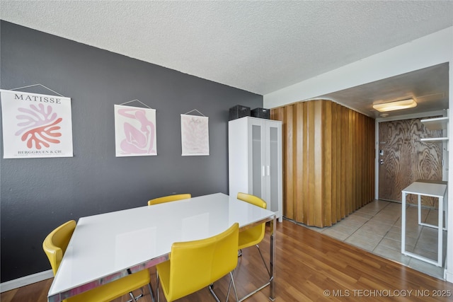 dining room featuring a textured ceiling and wood finished floors