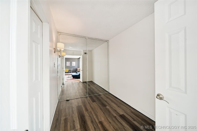 hall with dark wood-type flooring