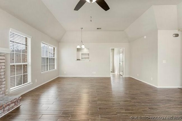 unfurnished room featuring dark wood finished floors, visible vents, a ceiling fan, vaulted ceiling, and baseboards