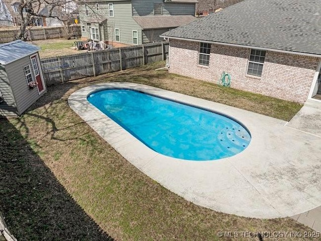 view of swimming pool featuring a fenced backyard, a fenced in pool, and an outdoor structure