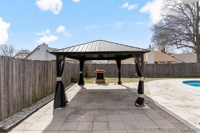 view of patio / terrace featuring a fenced in pool, a fenced backyard, and a gazebo