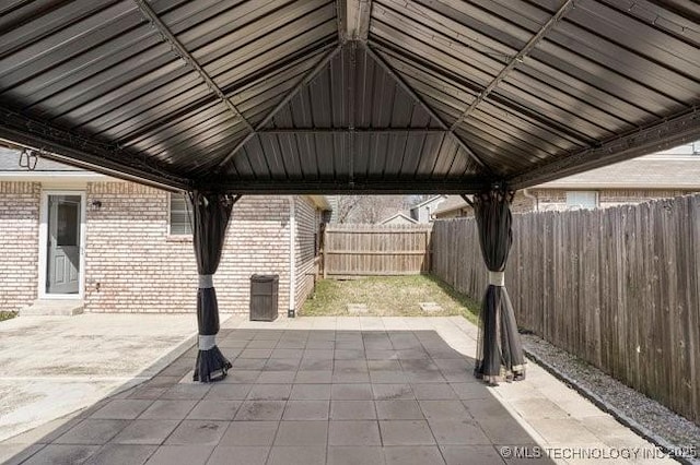 view of patio featuring a fenced backyard and a gazebo