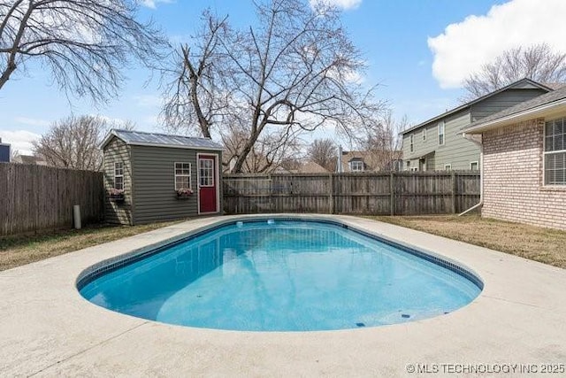 view of pool with an outbuilding, a storage unit, a fenced backyard, and a fenced in pool