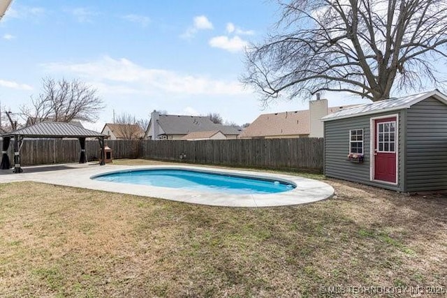 view of pool with a fenced backyard, an outdoor structure, a lawn, and a gazebo