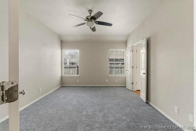 unfurnished bedroom with carpet floors, baseboards, and a ceiling fan