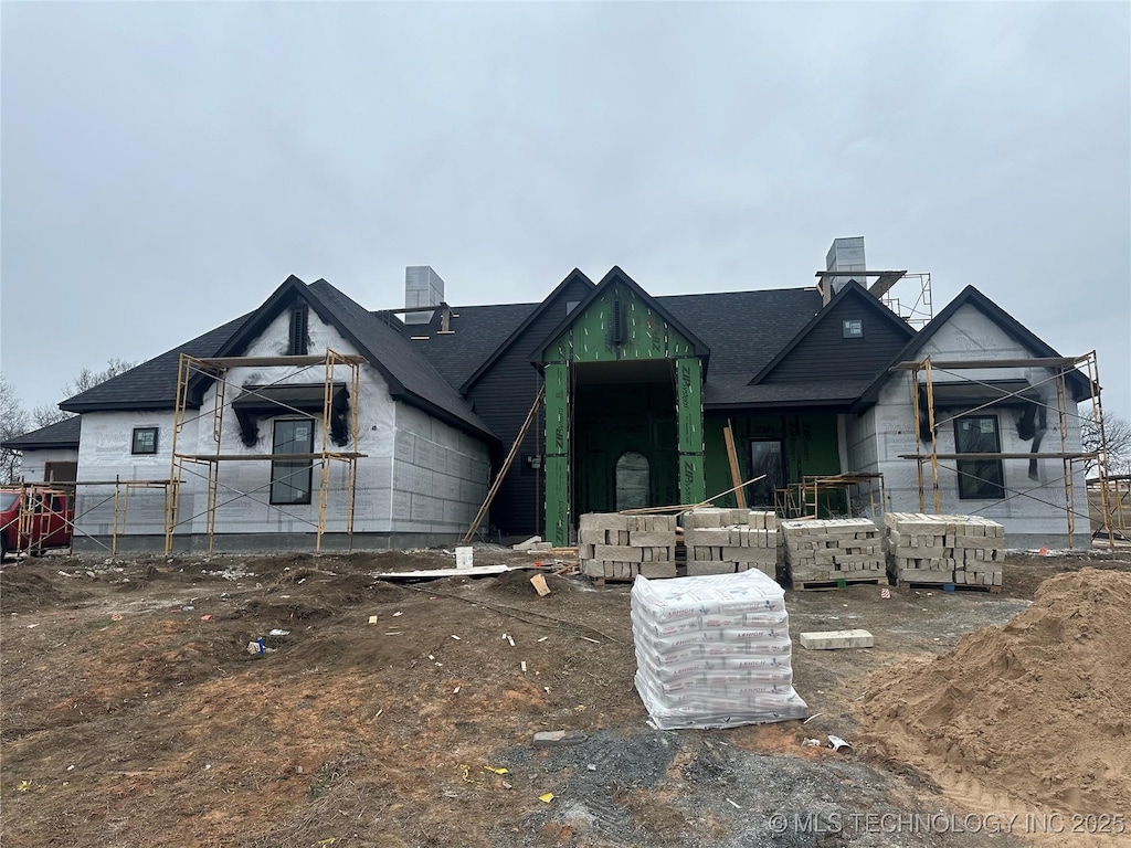 property under construction featuring a chimney and central AC