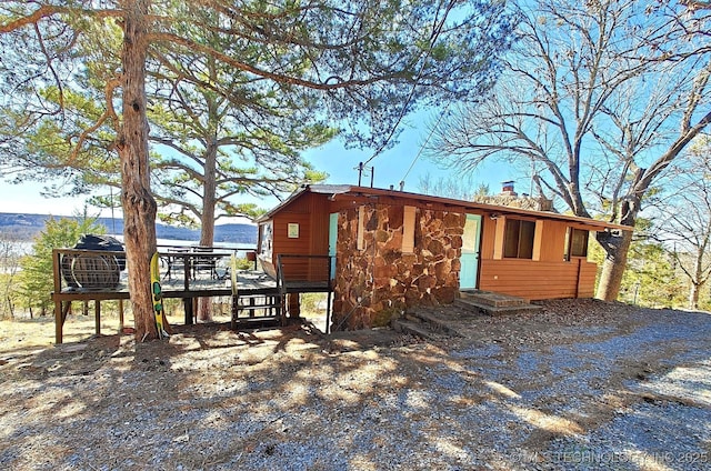 view of front of home featuring a deck and a chimney