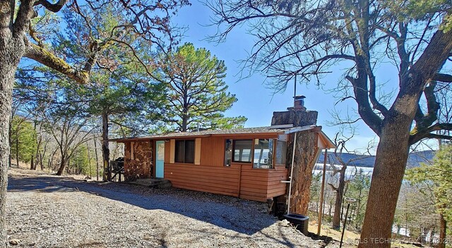 view of property exterior with a chimney