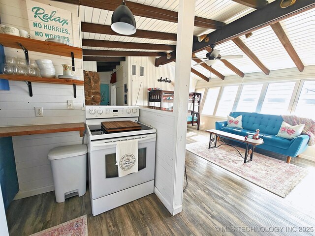 kitchen with electric stove, dark wood-style floors, ceiling fan, vaulted ceiling with beams, and wood walls