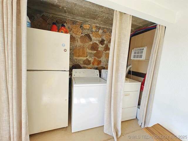 laundry room featuring laundry area, a wall mounted air conditioner, and washer and dryer