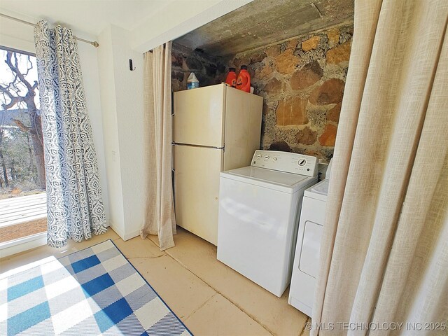 washroom with separate washer and dryer and a wealth of natural light