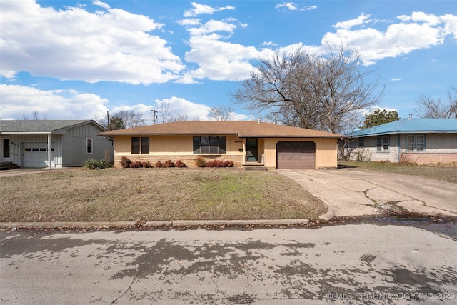 ranch-style home with a front lawn, driveway, and an attached garage