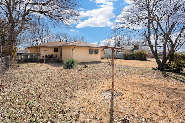 view of side of home featuring fence