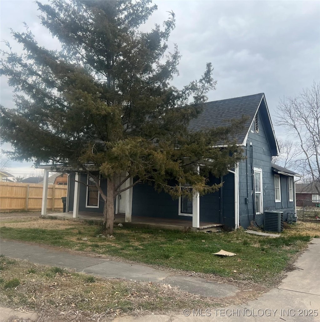 exterior space with fence and central AC unit