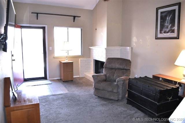 interior space featuring tile patterned flooring, a brick fireplace, and baseboards