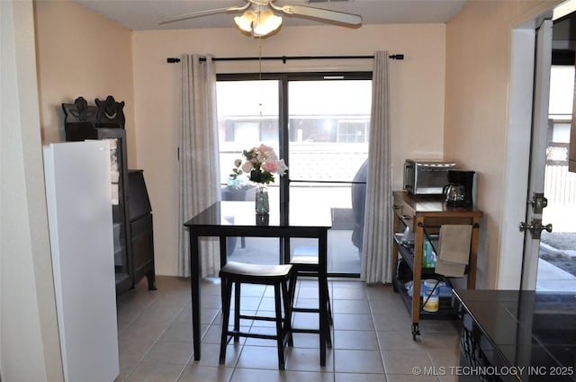 dining space featuring tile patterned flooring and ceiling fan