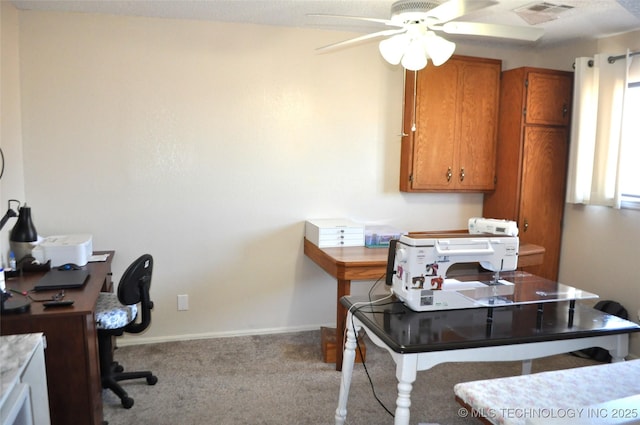 office space with ceiling fan, carpet floors, visible vents, and baseboards