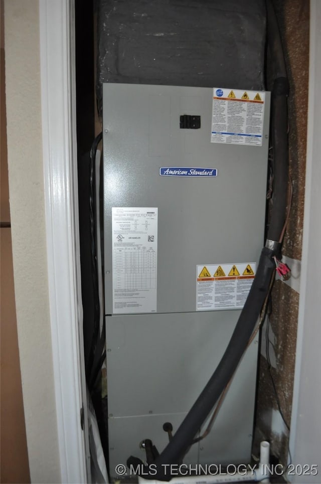 utility room featuring heating unit