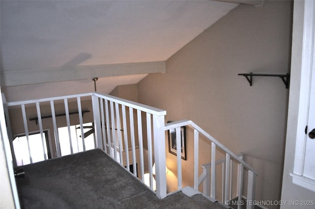 stairs featuring lofted ceiling with beams