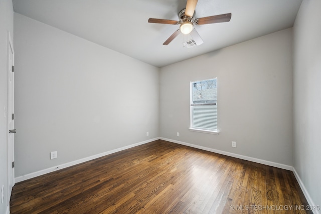 spare room with a ceiling fan, baseboards, visible vents, and wood finished floors