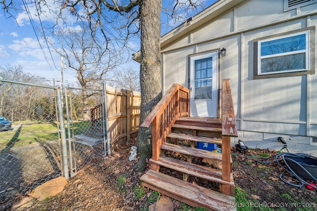 entrance to property featuring a gate and fence