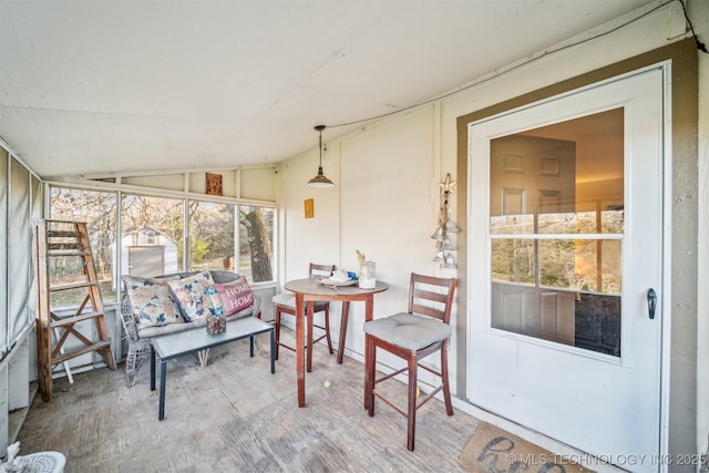 sunroom / solarium featuring vaulted ceiling