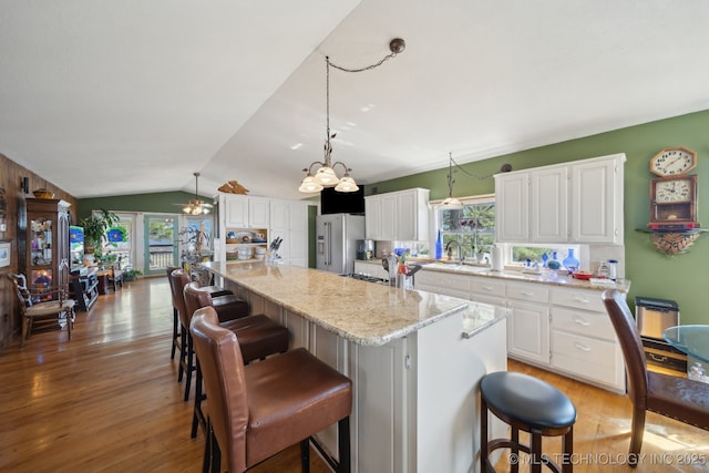 3126 E 490th Rd, Pryor, OK 74361 - kitchen featuring light wood-type flooring, lofted ceiling, a healthy amount of sunlight, and high quality fridge