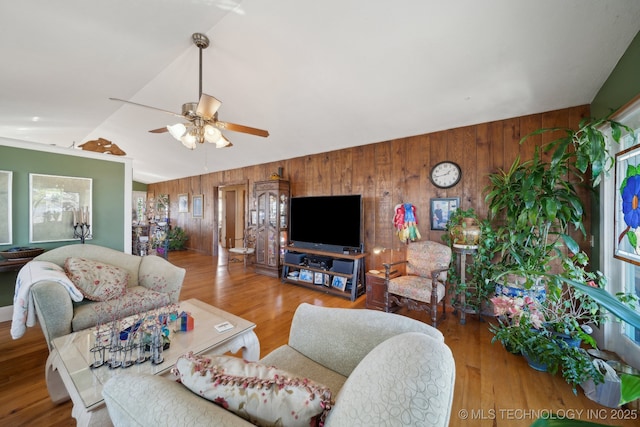 3126 E 490th Rd, Pryor, OK 74361 - living room featuring wood finished floors, ceiling fan, lofted ceiling, and wooden walls
