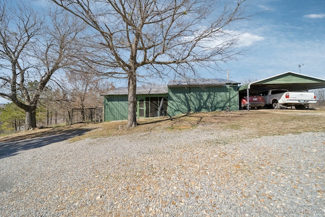 3126 E 490th Rd, Pryor, OK 74361 - view of front of house with board and batten siding and a carport